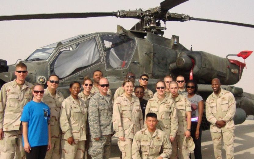 Jada Hamilton, fourth from left, with military unit in front of helicopter